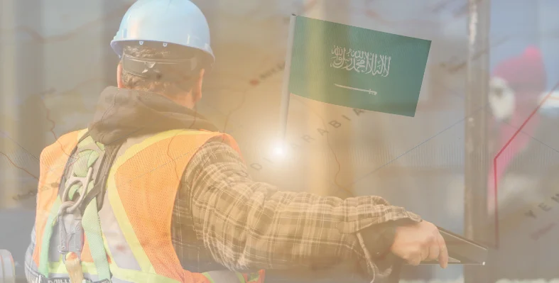 A construction worker wearing PPE overlaid with a map with the flag of Saudi Arabia stuck in it.