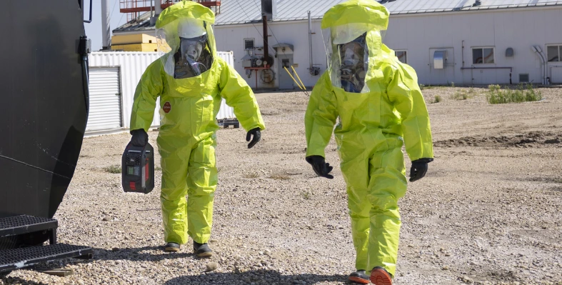 Two people in a yellow hazmat suit