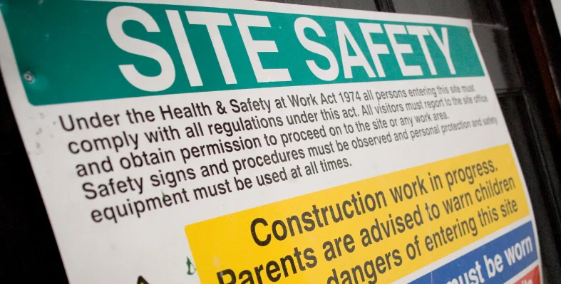 A Site Safety board on a construction site, displaying safety regulations.