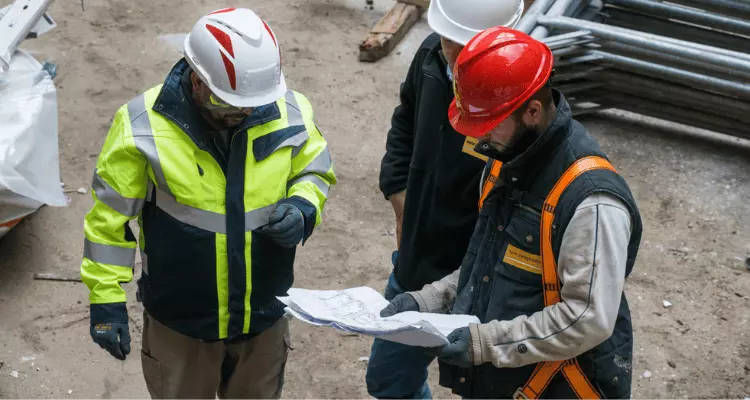 Workers with hard hats on. 