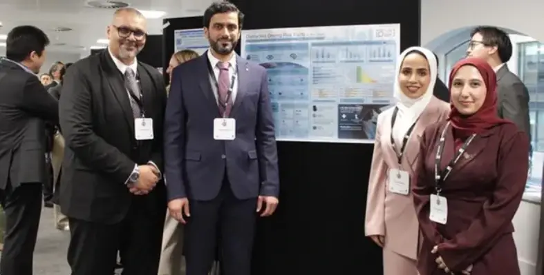 two_men_and_two_women_against_a_vision_board