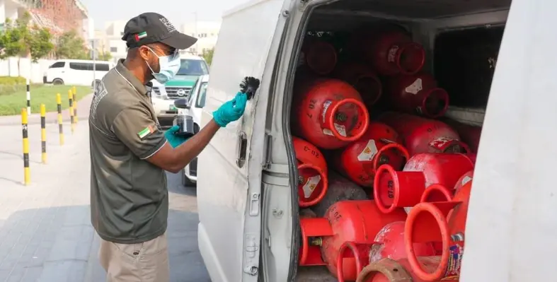 a_man_scrutinising_gas_cylinders