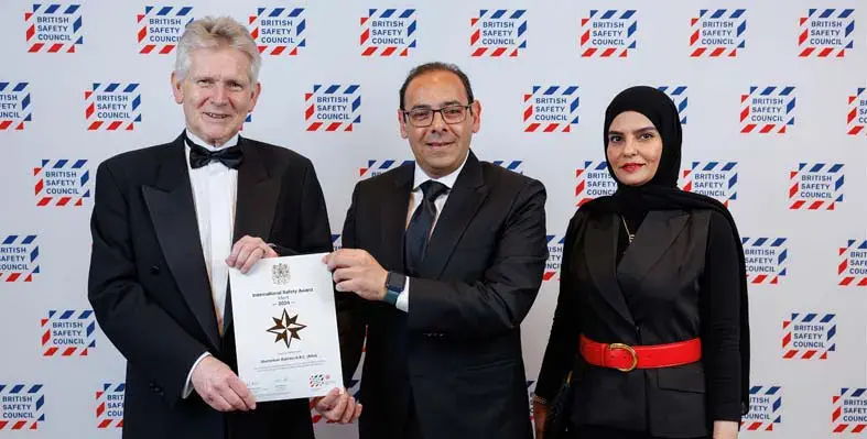 Men displaying award certificate