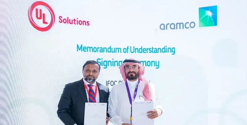 Two_men_signing_MoU_between_Aramco_and_UL_Solutions