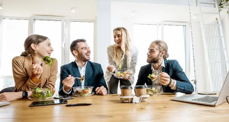 Picture of a group of young people eating healthily in the workplace