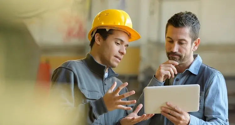 two_men_in_discussion_with_tablet